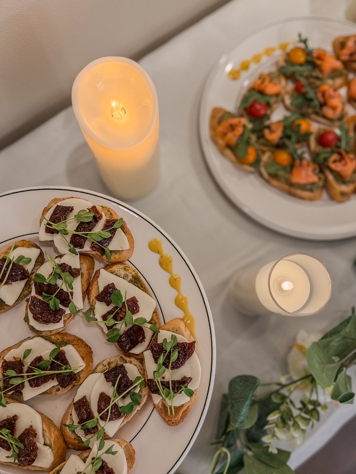 Grysh and Ko appetizers presented with candles and greenery
